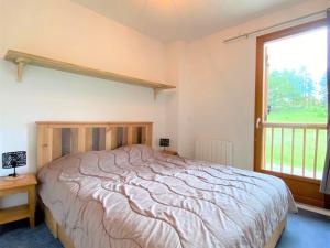a bedroom with a large bed and a window at Chalet Mitoyen 3 Pièces, 7 Pers, Résidence Les Flocons du Soleil, La Joue du Loup - FR-1-863-12 in Le Dévoluy +9 photos