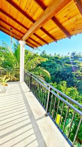 a balcony with a view of the forest at Mangrove Inn Mirissa in Kamburugamuwa