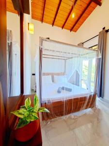 a bedroom with a tub in a room with a window at Mangrove Inn Mirissa in Kamburugamuwa +37 photos
