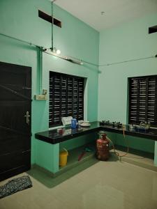 a room with a counter with a hose in it at JANATHA home stay in Varkala