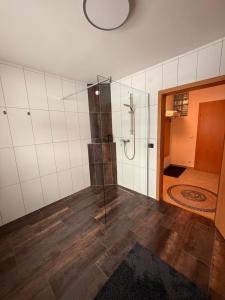 a bathroom with a shower with a glass door at Wohnung in Hüttau in Sonnberg +13 photos