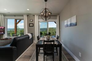 a dining room with a table and a couch at River & Garden View Suite of Kalama Oaks Lodge in Kelso