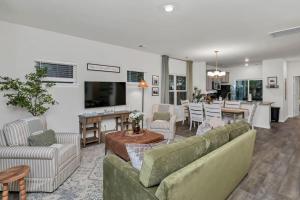 a living room with two couches and a dining room at The Augusta Cottage WECO 3Br in West Columbia