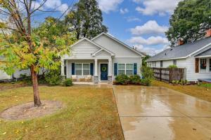 a white house with a tree in the yard at The Augusta Cottage WECO 3Br in West Columbia