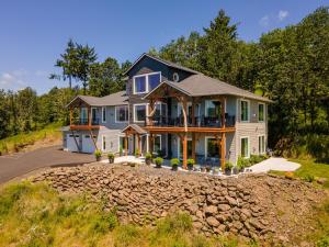 a large house on the side of a road at River & Garden View Suite of Kalama Oaks Lodge in Kelso