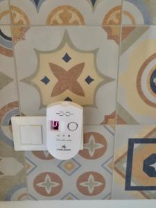 a toilet in a bathroom with a tile wall at Casa Sabina in Sanremo
