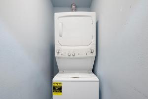 a white washer and dryer in a corner at 70 Steps to Beach Dewey Beach in Dewey Beach +30 photos