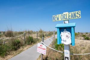 a street sign for new orleans with a sign on it at 70 Steps to Beach Dewey Beach in Dewey Beach