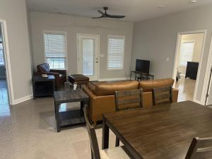 a living room with a couch and a table at The Buford T Justice Suite in Lexington