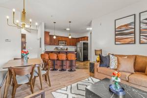 a living room and kitchen with a couch and a table at Rockies Getaway Condo With Mountain View in Canmore