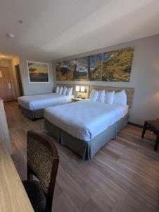 a hotel room with two beds in a room at Days Inn & Suites by Wyndham Castle Rock in Castle Rock