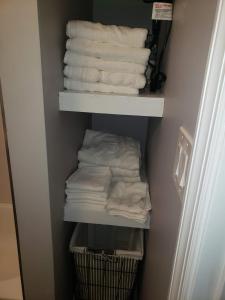 a closet with white towels and a basket of towels at Attractive and Cozy Apartment - 4 bdrms 2 bths in Paterson +24 photos