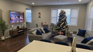a living room with a christmas tree in the corner at Attractive and Cozy Apartment - 4 bdrms 2 bths in Paterson