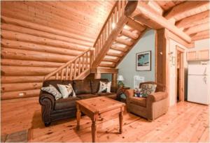 a living room with a couch and a table at Charming Rustic Cabin Perfect for Groups in Golden