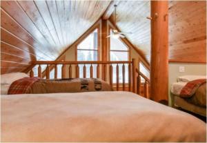 a bedroom with two beds and a large window at Charming Rustic Cabin Perfect for Groups in Golden +10 photos