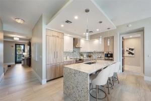 eine große Küche mit einer großen Insel mit Barhockern in der Unterkunft Chic Three-Bedroom Waterfront Condo With Private Balcony in Fort Lauderdale