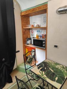 a small kitchen with a table and a microwave at Casa Norida in Bordighera +29 photos