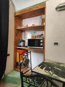 a microwave sitting on a shelf in a room at Casa Norida in Bordighera