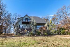 a house with a large yard in front of it at Emerald Point, Lakefront with Gorgeous Views in McAlester