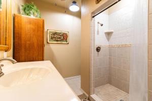 a bathroom with a sink and a shower at Emerald Point, Lakefront with Gorgeous Views in McAlester +50 photos