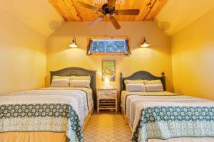 a bedroom with two beds and a ceiling fan at Emerald Point, Lakefront with Gorgeous Views in McAlester