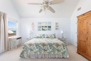 a bedroom with a bed and a ceiling fan at Oceanfront Private Beach Access & Community Pool in Kitty Hawk Beach