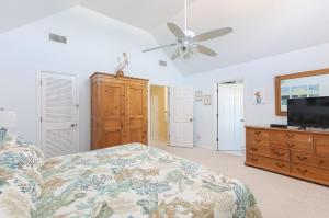 a bedroom with a bed and a ceiling fan at Oceanfront Private Beach Access & Community Pool in Kitty Hawk Beach +45 photos
