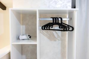 a white closet with a white curtain and a toaster at Dimora dei Venulei in Ferentino +9 photos