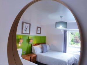 Ένα ή περισσότερα κρεβάτια σε δωμάτιο στο The Osprey Hotel