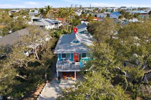 an aerial view of a blue house with a porch at Sand Dollar Suite by Sun Palace Vacations in Fort Myers Beach