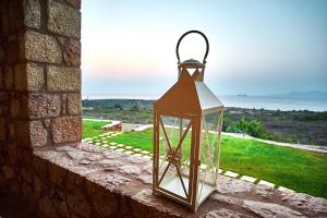 a glass lantern on a wall with a view at Element Hotel in Elafonisos
