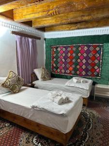 En eller flere senge i et værelse på Mekhtarr Anbar Historical Hotel