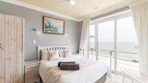 a bedroom with a bed with a view of the ocean at The Sunset Villas in Velddrif +105 photos