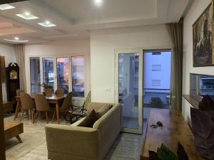 a living room with a couch and a table at Luxe & Sérénité Sahloul 4 in Sousse