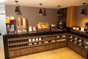 a restaurant with a counter with food on it at Hotel Continental ByHours in Bogotá
