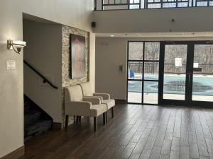 a waiting room with two chairs and a table at Red Roof Inn & Suites Middleborough in Middleboro