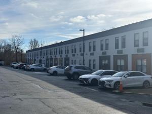 a row of cars parked in front of a building at Red Roof Inn & Suites Middleborough in Middleboro