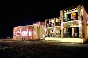 a large building with lights on it at night at Element Hotel in Elafonisos