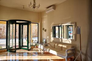 a living room with a couch and some windows at Element Hotel in Elafonisos