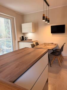 a kitchen with a wooden counter top and a table at LevelUp 5von5 in Koblenz