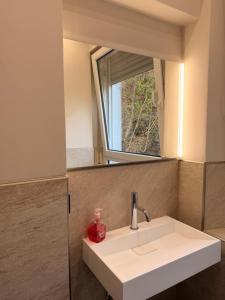 a bathroom with a sink and a mirror at LevelUp 5von5 in Koblenz