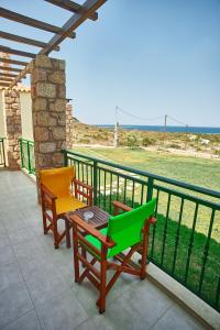 two chairs and a table on a balcony at Element Hotel in Elafonisos