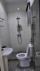 a bathroom with a toilet and a sink at White Orchid Inn in Ibadan