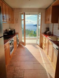a kitchen with a large glass door with a view at Gaia Skiathos Apartments in Achladies