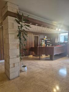 a lobby with a palm tree in the middle of a room at Casa Sabina in Sanremo