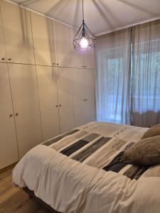 a bedroom with a bed with white cabinets and a light at Casa Sabina in Sanremo +17 photos