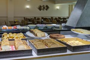 a buffet with many different types of bread and pastries at Transamerica Executive Perdizes in São Paulo