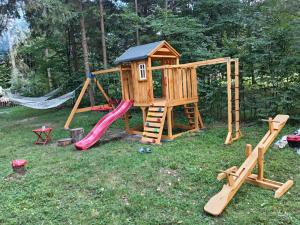 a play set with a slide and a playground at Misha's House in Porumbacu de Sus