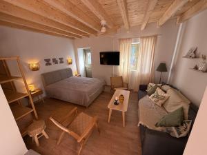 a living room with a bed and a couch at Kantouni Corfu in Potamós