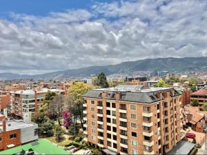 an aerial view of a city with buildings and mountains at EspacioYa By Mario Rental Calle 100 in Bogotá